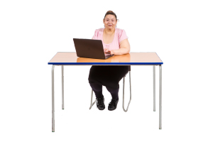 person sitting at a desk with a laptop