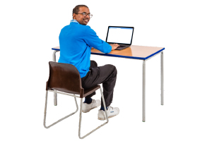 person at a desk on a laptop