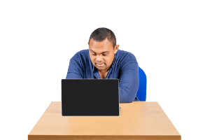 person sitting at a desk with a laptop