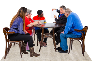 people sitting around a table at a ndis practice standards meeting