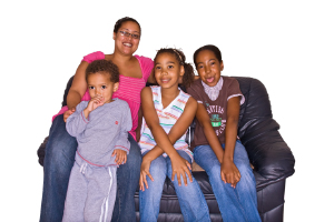 mother and three children sitting on a sofa