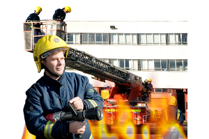 firefighter standing infront of a burning building