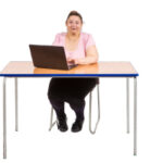 woman sitting at a desk using a laptop to search for information