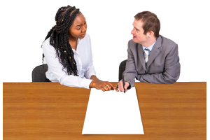 two people at a desk working on a plan