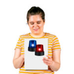 woman reading a fact sheet about emergencies with a blue and red siren on the cover