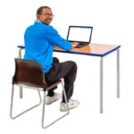 man sitting at a desk using a computer to look for information