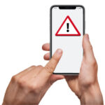 person pointing at a mobile phone with a caution symbol which is a red triangle with a black exclamation in the middle