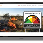 laptop with screen shot of the afdrs website with the fire rating scale and a bush fire