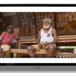 picture of two aboriginal men sitting in their community shed