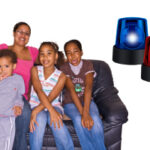 picture of a mother and three children sitting on a couch with a blue siren and a red siren next to them