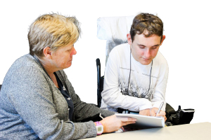 person reading a document with a supporter