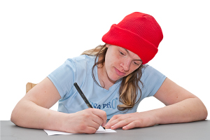 person writing on a piece of paper