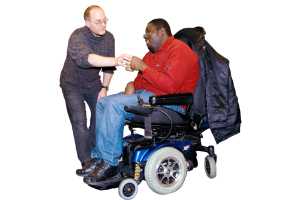 person supporting someone in a wheelchair