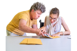 a person helping another person make something