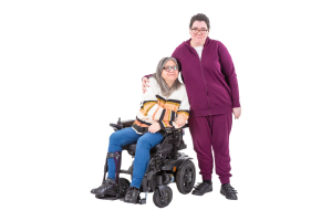 person supporting someone in a wheelchair